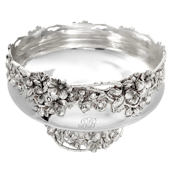 Gilded Age sterling silver centerpiece bowl. Made by Ferdinand Fuchs in New York, ca 1900. Round solid well. Sides lobed and turned-down with pierced diaper in engraved leafy scrolled frames. Rim has reeded leaf-capped scrolls interspersed with leaves and shells