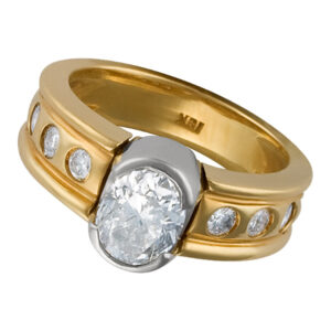 Semi Bezel set oval cut diamond ring in 18k yellow and white gold