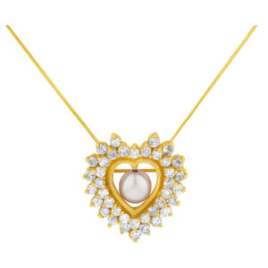 Heart shaped pearl & diamond brooch in 14k yellow gold.