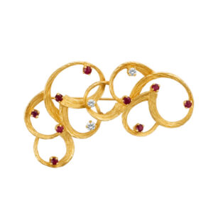 Elegant swirl broach with ruby & diamond accents in 14k