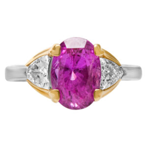 Adorable 4.06 ct oval cut pink sapphire in platinum and 18k mounting trillion cut diamonds G color, VS clarity.