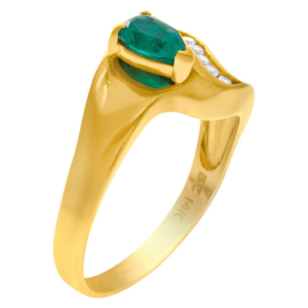 Pear shaped emerald ring with diamond accents in 14k gold. Size 10