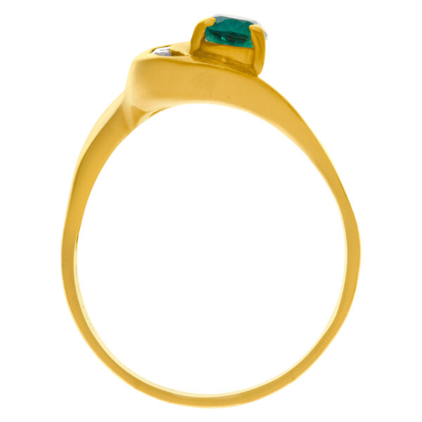 Pear shaped emerald ring with diamond accents in 14k gold. Size 10