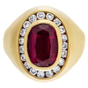 Oval ruby ring with diamond accents in 18k yellow gold