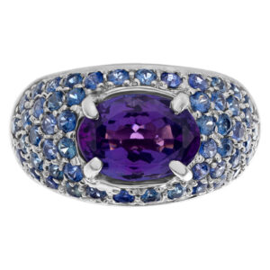 Bright oval ceneter (approximately 2 carats) tanzanite surrounded by sparkling pave tanzanite gems in 14k white gold