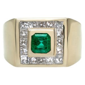 Attractive ring with over 1.0 carat Emerald surrounded by 16 Princess cut Diamonds set in 14K YG