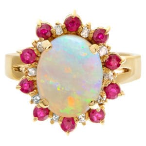 Opal ring in 14k yellow gold surrounded by diamonds and rubies.