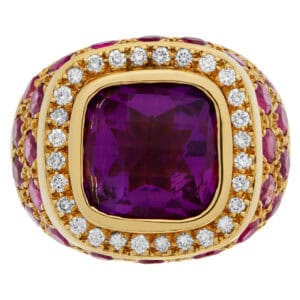 Cocktail ring in 18k yellow gold with center amethyst cushion shape briolette cut surrouned  by diamonds and rubies