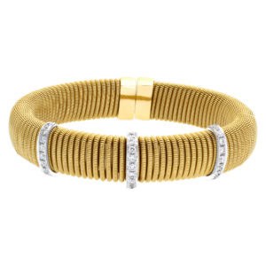 Stylish Italian design wrapped coil bangle in 18k yellow gold with 3 diamond bar stations.