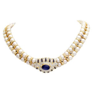 Glamorous double strand pearl necklace with diamonds & sapphires, set in 18k yellow gold.