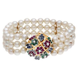 Three strand pearl bracelet with 18k gold clasp with emeralds, ruby and sapphire