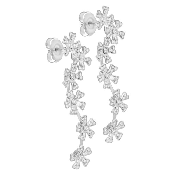 Hanging pave diamond floating flower earrings in 18K white gold.