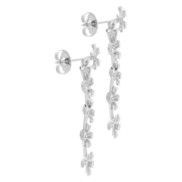 Hanging pave diamond floating flower earrings in 18K white gold.