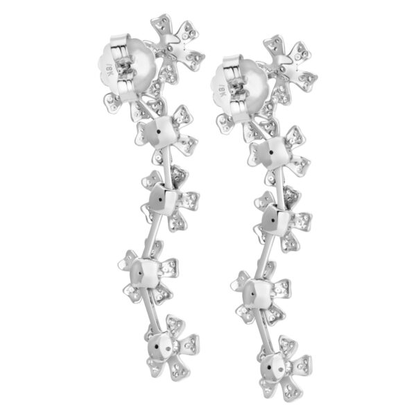 Hanging pave diamond floating flower earrings in 18K white gold.