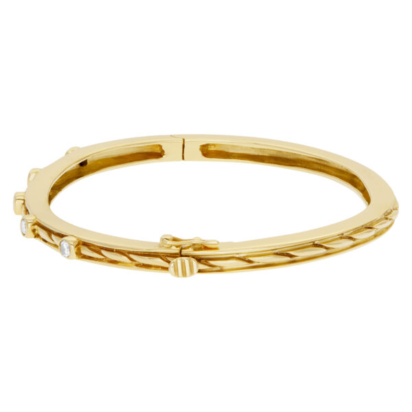 Bangle bracelet with 5 swirls in 14k yellow gold and diamonds