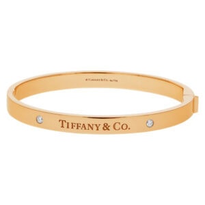 Tiffany & Co. Hinged bangle with two diamonds in 18k yellow. Medium size