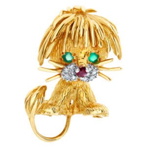 Lion pin in 14k yellow gold with 2 emerald eyes, ruby nose,and pave diamond jowls.